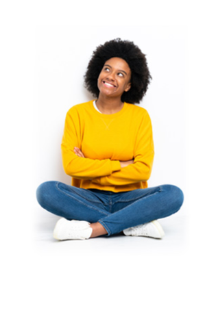 Person in a yellow sweater smiling and looking up